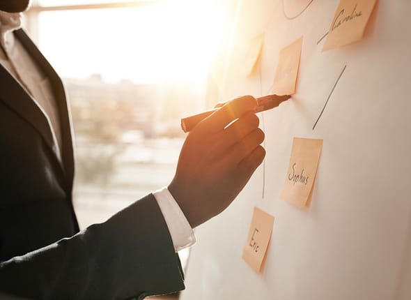 Cropped,Shot,Of,Businessman,Putting,His,Ideas,On,White,Board